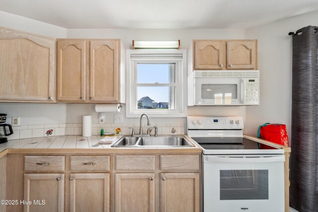 3045 Island Dr, North Topsail Beach, NC 28460 - kitchen with white appliances, light brown cabinetry, a sink, and tile countertops