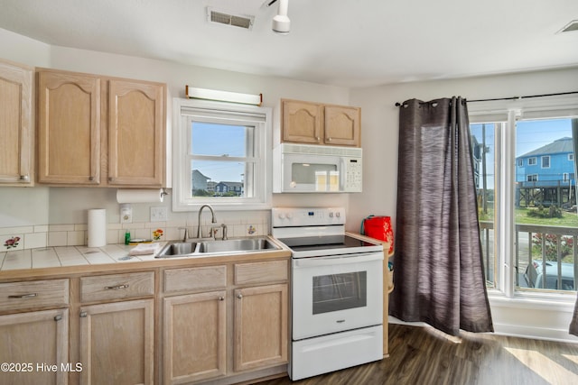 3045 Island Dr, North Topsail Beach, NC 28460 - kitchen featuring white appliances, light brown cabinetry, a sink, and tile counters