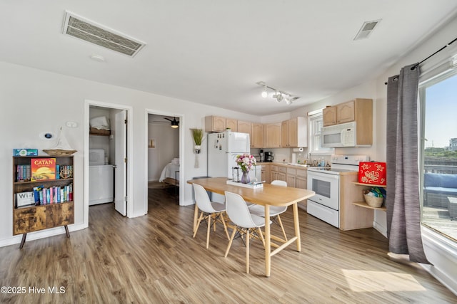 3045 Island Dr, North Topsail Beach, NC 28460 - kitchen with white appliances, light brown cabinetry, washer / dryer, light wood finished floors, and light countertops