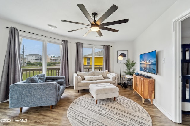 3045 Island Dr, North Topsail Beach, NC 28460 - living room with ceiling fan, plenty of natural light, wood finished floors, and baseboards