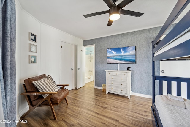3045 Island Dr, North Topsail Beach, NC 28460 - bedroom featuring wood finished floors, crown molding, baseboards, ensuite bathroom, and ceiling fan
