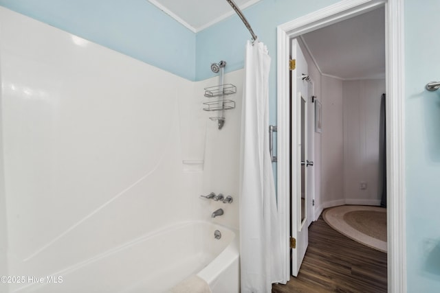 3045 Island Dr, North Topsail Beach, NC 28460 - bathroom featuring shower / tub combo with curtain and wood finished floors
