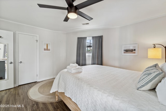 3045 Island Dr, North Topsail Beach, NC 28460 - bedroom featuring wood finished floors, crown molding, and a ceiling fan