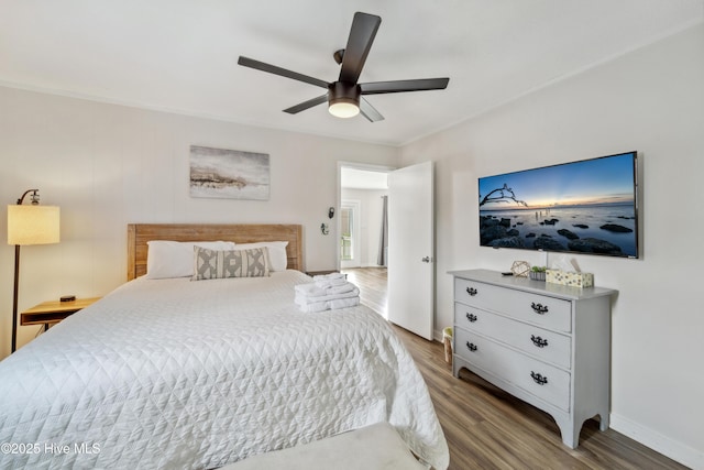 3045 Island Dr, North Topsail Beach, NC 28460 - bedroom with wood finished floors, baseboards, and ceiling fan