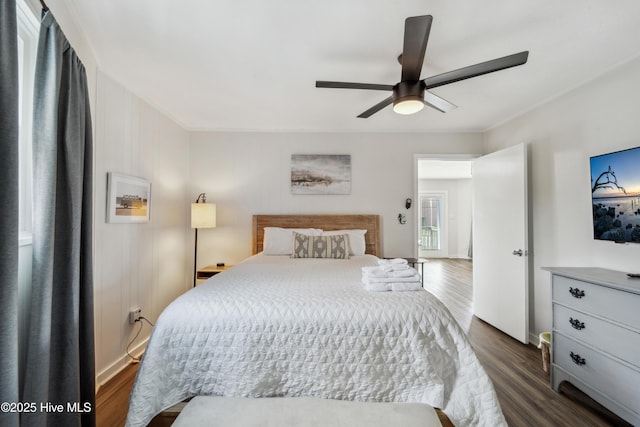 3045 Island Dr, North Topsail Beach, NC 28460 - bedroom with dark wood-style floors and ceiling fan