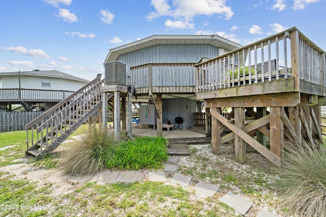 3045 Island Dr, North Topsail Beach, NC 28460 - rear view of house with stairway and a wooden deck