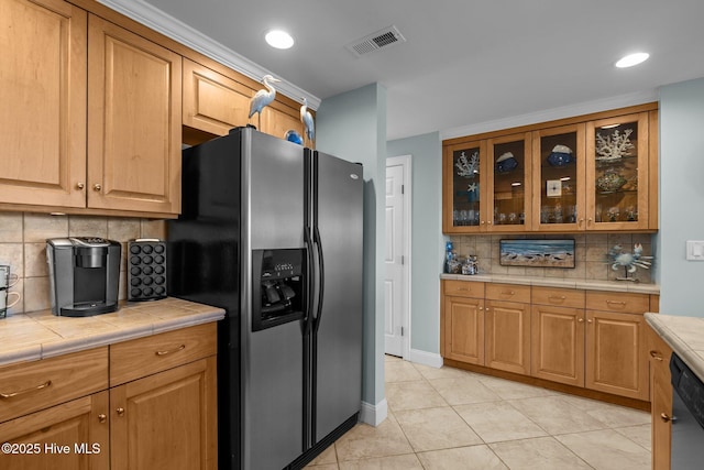 331 Salter Path Rd Unit 211, Pine Knoll Shores, NC 28512 - kitchen with stainless steel appliances, tile counters, tasteful backsplash, glass insert cabinets, and light tile patterned floors