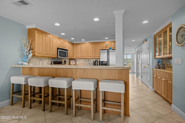 331 Salter Path Rd Unit 211, Pine Knoll Shores, NC 28512 - kitchen featuring appliances with stainless steel finishes, backsplash, a peninsula, glass insert cabinets, and recessed lighting