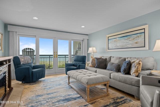 331 Salter Path Rd Unit 211, Pine Knoll Shores, NC 28512 - living room with a glass covered fireplace, recessed lighting, french doors, and light tile patterned floors