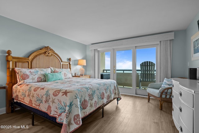 331 Salter Path Rd Unit 211, Pine Knoll Shores, NC 28512 - bedroom featuring access to exterior and wood finished floors