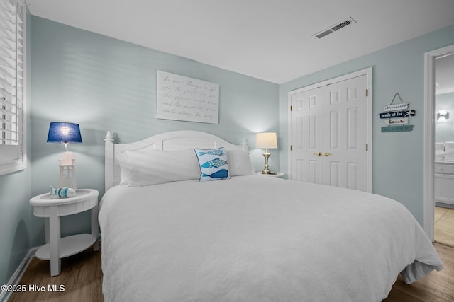 331 Salter Path Rd Unit 211, Pine Knoll Shores, NC 28512 - bedroom with wood finished floors, baseboards, and a closet