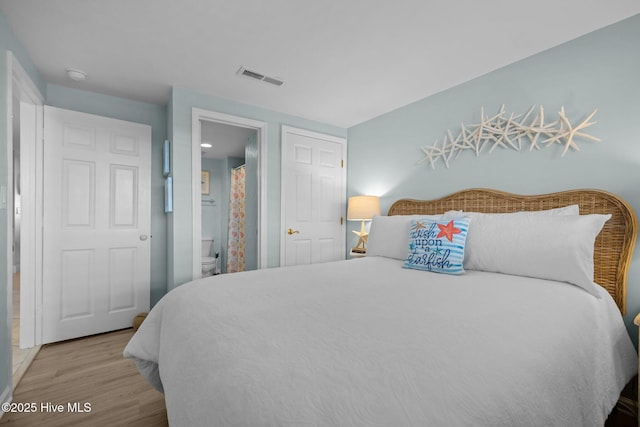 331 Salter Path Rd Unit 211, Pine Knoll Shores, NC 28512 - bedroom with wood finished floors and connected bathroom