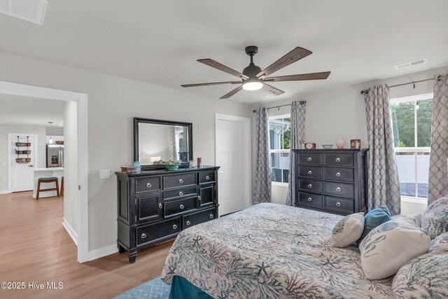 818 Ashlar Cir, Navassa, NC 28451 - bedroom featuring wood finished floors, baseboards, multiple windows, and ceiling fan