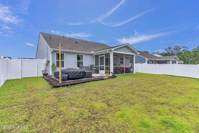 818 Ashlar Cir, Navassa, NC 28451 - rear view of house featuring a sunroom, a ceiling fan, a shingled roof, and a hot tub