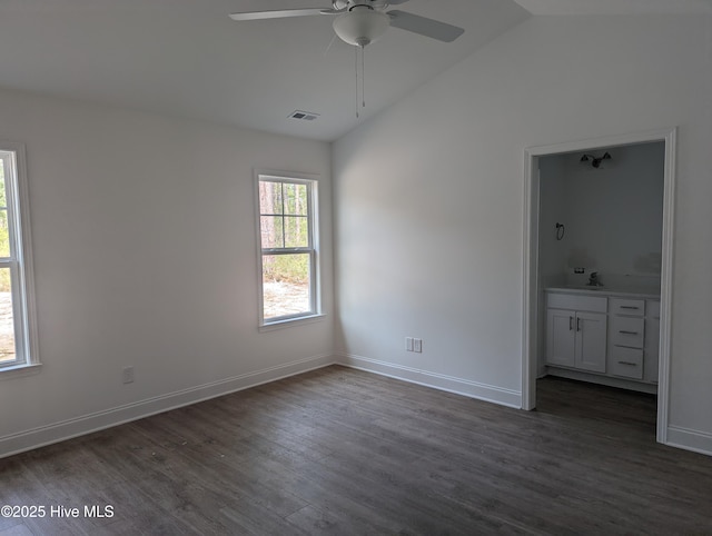 941 Downing Rd, Southport, NC 28461 - unfurnished bedroom with vaulted ceiling, dark wood-style flooring, a sink, ensuite bath, and baseboards