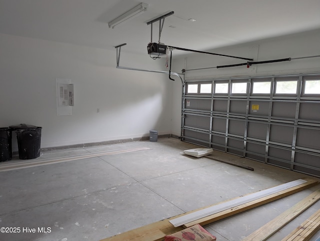 941 Downing Rd, Southport, NC 28461 - garage with a garage door opener, baseboards, and electric panel