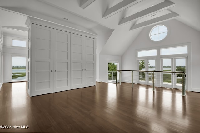 1064 Ocean Ridge Dr, Wilmington, NC 28405 - unfurnished living room with high vaulted ceiling, wood finished floors, and beamed ceiling