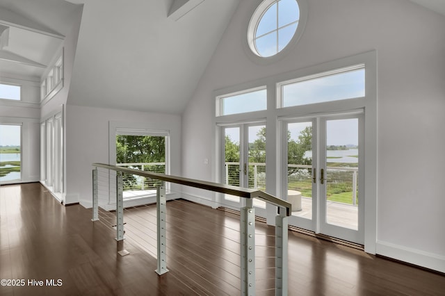 1064 Ocean Ridge Dr, Wilmington, NC 28405 - hall featuring high vaulted ceiling, an upstairs landing, dark wood-type flooring, and baseboards