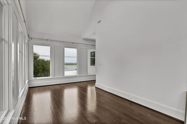 1064 Ocean Ridge Dr, Wilmington, NC 28405 - spare room with dark wood-style flooring, baseboards, and high vaulted ceiling