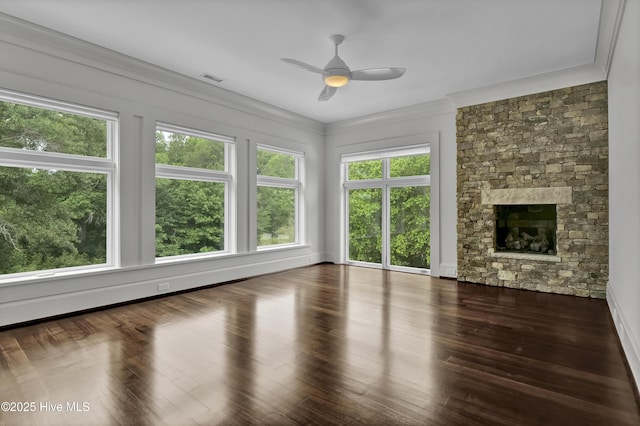 1064 Ocean Ridge Dr, Wilmington, NC 28405 - unfurnished living room featuring ceiling fan, a fireplace, wood finished floors, and crown molding