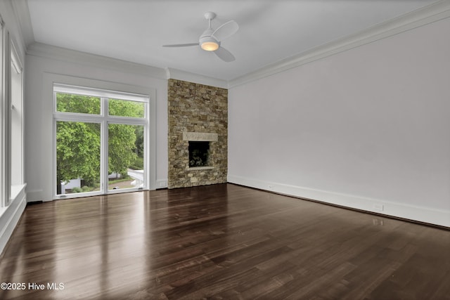 1064 Ocean Ridge Dr, Wilmington, NC 28405 - unfurnished living room featuring a ceiling fan, wood finished floors, crown molding, a stone fireplace, and baseboards