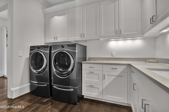 1064 Ocean Ridge Dr, Wilmington, NC 28405 - laundry area featuring cabinet space, dark wood finished floors, washer and clothes dryer, and baseboards