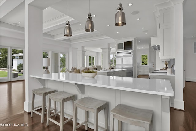 1064 Ocean Ridge Dr, Wilmington, NC 28405 - kitchen with stainless steel built in fridge, decorative columns, a spacious island, light countertops, and beamed ceiling