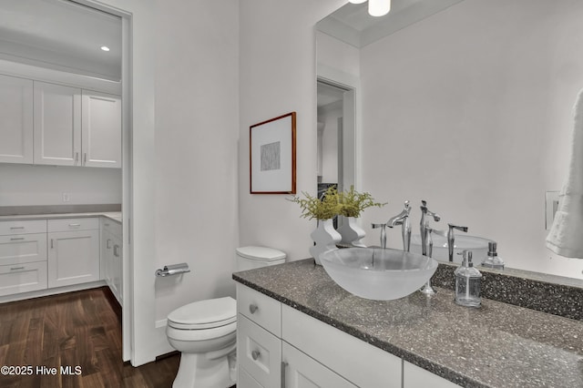1064 Ocean Ridge Dr, Wilmington, NC 28405 - bathroom featuring vanity, wood finished floors, and toilet