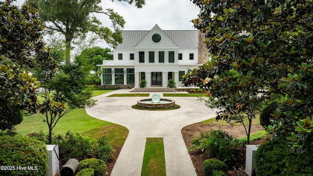 1064 Ocean Ridge Dr, Wilmington, NC 28405 - rear view of house featuring a standing seam roof, curved driveway, and metal roof