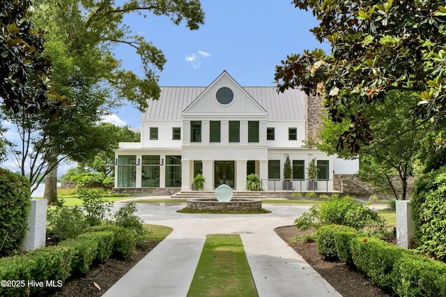1064 Ocean Ridge Dr, Wilmington, NC 28405 - rear view of property featuring a standing seam roof, stone siding, and metal roof