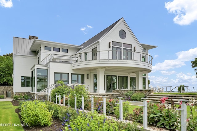 1064 Ocean Ridge Dr, Wilmington, NC 28405 - view of front facade with a balcony and a chimney