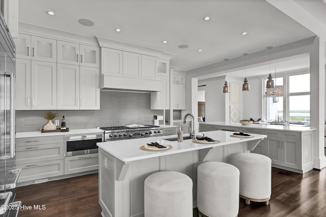 1064 Ocean Ridge Dr, Wilmington, NC 28405 - kitchen featuring a sink, dark wood finished floors, a breakfast bar, tasteful backsplash, and recessed lighting