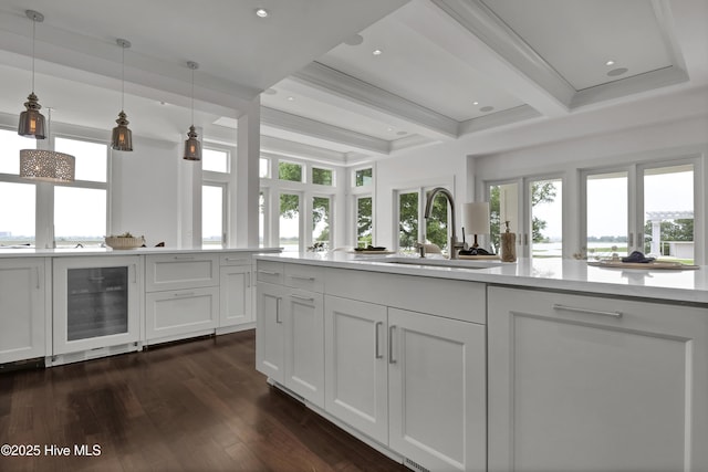 1064 Ocean Ridge Dr, Wilmington, NC 28405 - kitchen with beverage cooler, a sink, beam ceiling, healthy amount of natural light, and dark wood finished floors