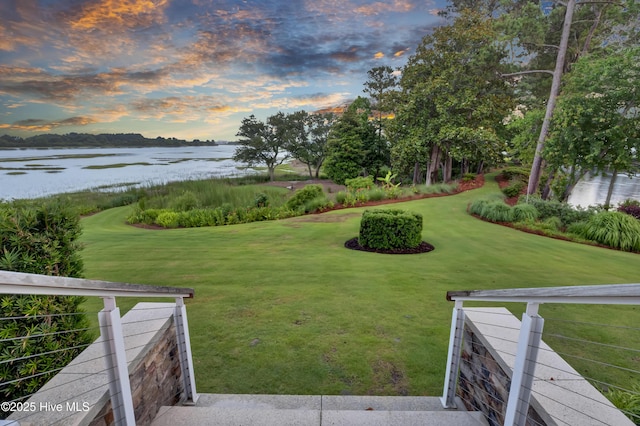 1064 Ocean Ridge Dr, Wilmington, NC 28405 - yard at dusk featuring a water view and a lawn