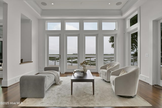 1064 Ocean Ridge Dr, Wilmington, NC 28405 - living room with a tray ceiling, wood finished floors, and crown molding