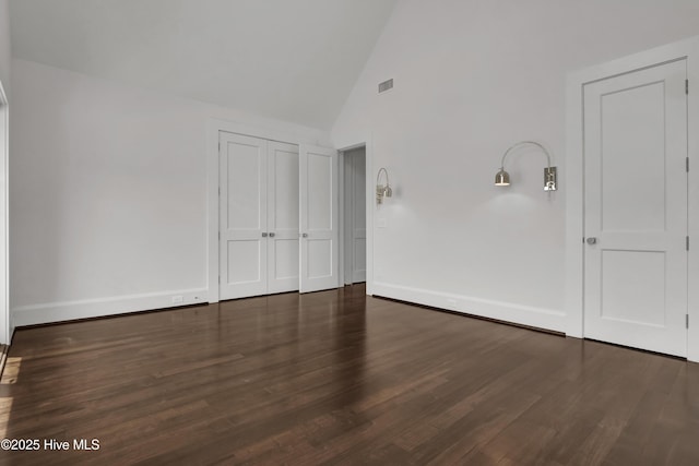 1064 Ocean Ridge Dr, Wilmington, NC 28405 - unfurnished bedroom with wood finished floors, high vaulted ceiling, baseboards, and a closet
