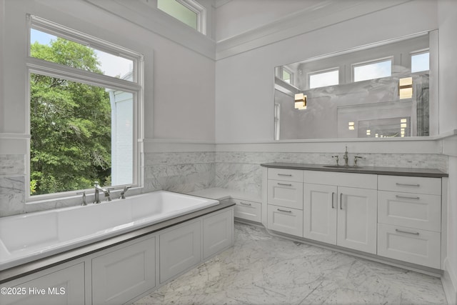 1064 Ocean Ridge Dr, Wilmington, NC 28405 - bathroom with marble tiled floors, vanity, a tub to relax in, wainscoting, and tile walls