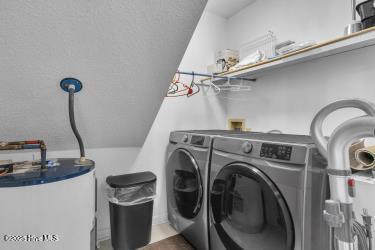 6707 Kings Lynn Dr, Oak Island, NC 28465 - washroom with washing machine and clothes dryer and water heater