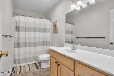 6707 Kings Lynn Dr, Oak Island, NC 28465 - bathroom with vanity, toilet, and a shower with curtain