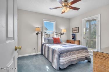 6707 Kings Lynn Dr, Oak Island, NC 28465 - bedroom featuring baseboards, a ceiling fan, and ensuite bath