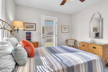 6707 Kings Lynn Dr, Oak Island, NC 28465 - bedroom featuring a ceiling fan