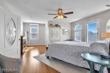 6707 Kings Lynn Dr, Oak Island, NC 28465 - bedroom featuring wood finished floors