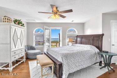 6707 Kings Lynn Dr, Oak Island, NC 28465 - bedroom with wood finished floors and a ceiling fan