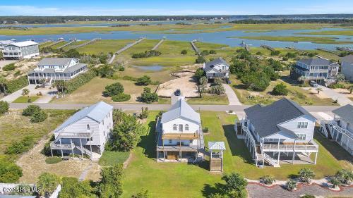 6707 Kings Lynn Dr, Oak Island, NC 28465 - aerial perspective of suburban area with a nearby body of water