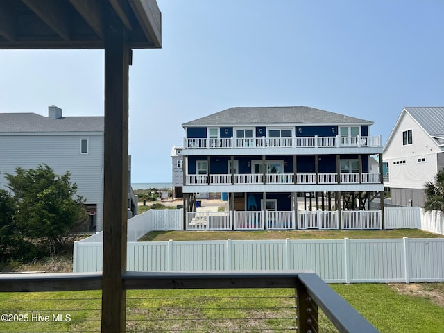 6707 Kings Lynn Dr, Oak Island, NC 28465 - rear view of house featuring a balcony