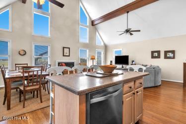 6707 Kings Lynn Dr, Oak Island, NC 28465 - kitchen with a ceiling fan, dishwasher, high vaulted ceiling, beamed ceiling, and light wood finished floors
