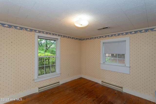 1772 NC-5 Hwy, Aberdeen, NC 28315 - empty room with hardwood / wood-style floors, a baseboard heating unit, baseboards, wallpapered walls, and crown molding