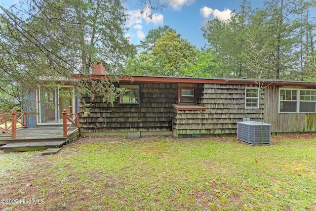 1772 NC-5 Hwy, Aberdeen, NC 28315 - view of home's exterior with central air condition unit, a chimney, a lawn, and a wooden deck