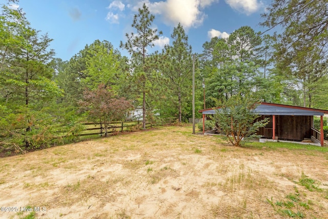 1772 NC-5 Hwy, Aberdeen, NC 28315 - view of yard featuring a carport and an outbuilding