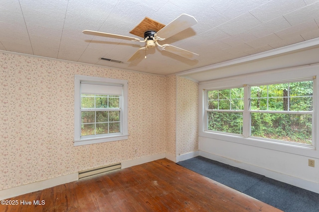 1772 NC-5 Hwy, Aberdeen, NC 28315 - empty room with a baseboard heating unit, dark wood-style flooring, baseboards, and a ceiling fan